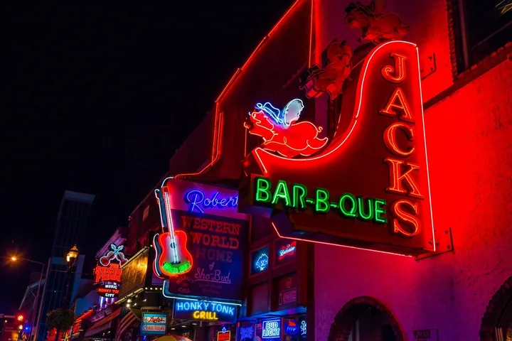 Neon signs and bars on Lower Broadway at night