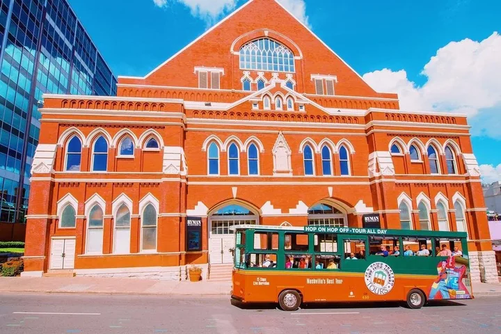 The red-brick Ryman Auditorium seen from the street with a trolley in front